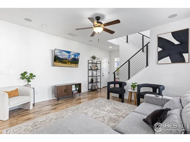 a living room with furniture and a dining table