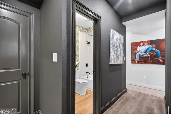 a view of a hallway with paintings on the wall