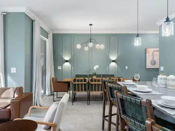 a view of a dining room with furniture and chandelier