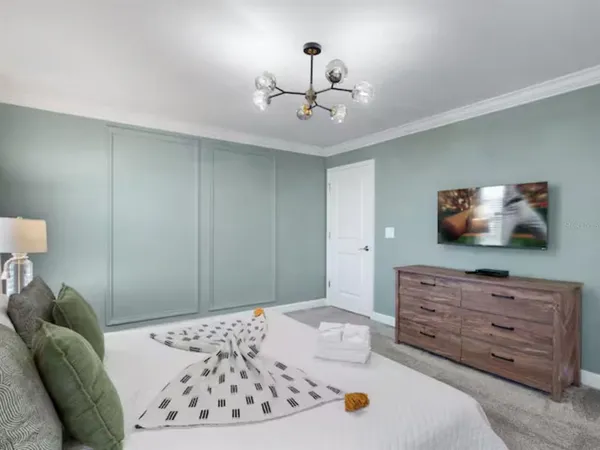 a bedroom with a bed and a flat screen tv