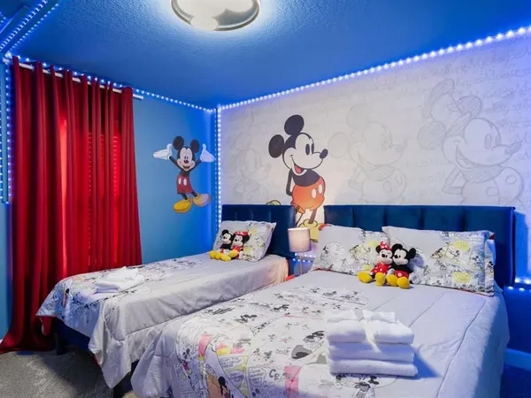 a bedroom with bed and wooden floor