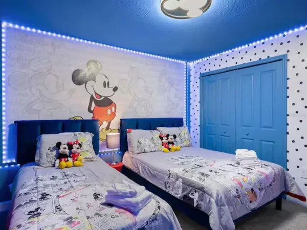 a bedroom with bed and wooden floor