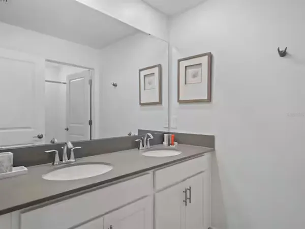 a bathroom with double sink and a mirror