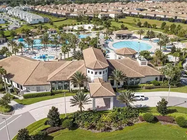 an aerial view of a swimming pool with outdoor seating