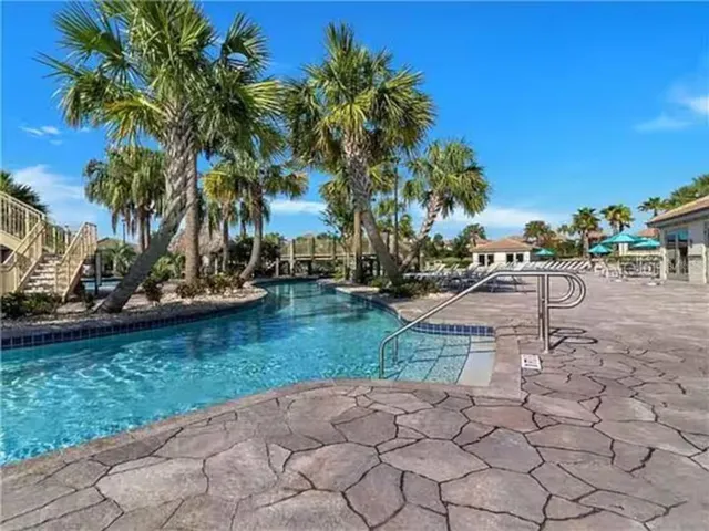 a view of a swimming pool and lounge chairs