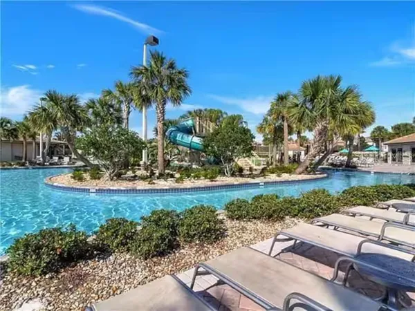a swimming pool with lots of palm trees