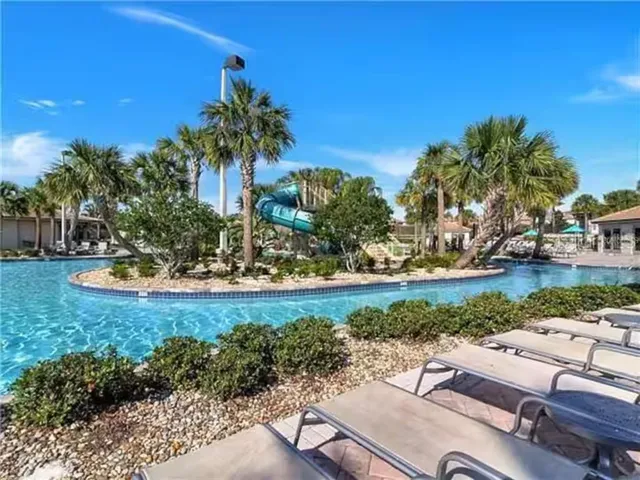 a swimming pool with lots of palm trees