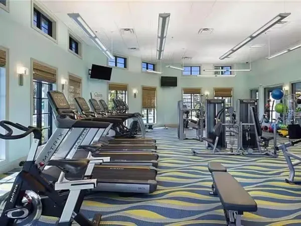a living room with fireplace furniture and a chandelier