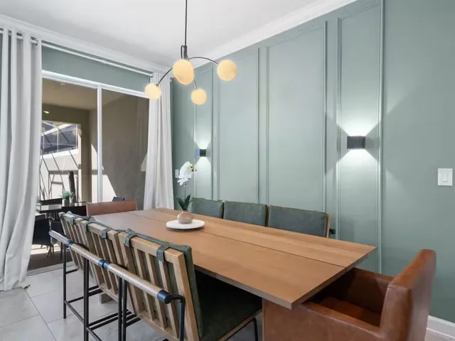 a dining room with a table chairs and chandelier