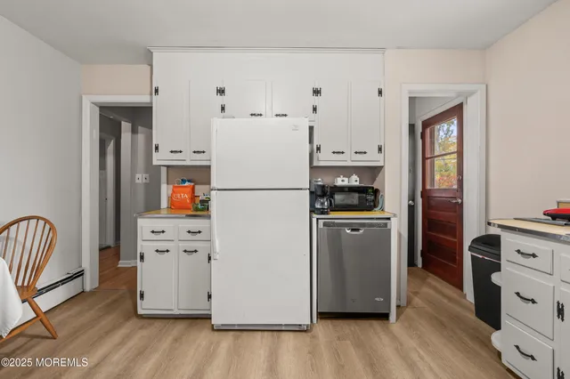 a bedroom with a bed and a wooden floor
