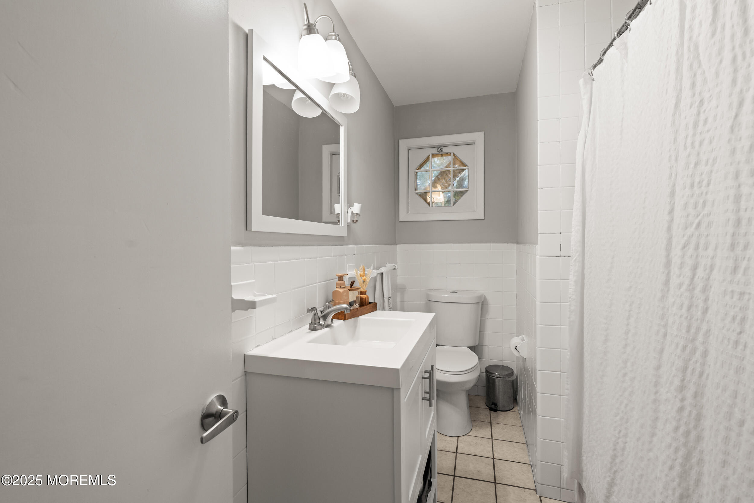271 Jerome Avenue Oakhurst, NJ 07755 - Photo 18 of 39 a bathroom with a sink a toilet and a mirror