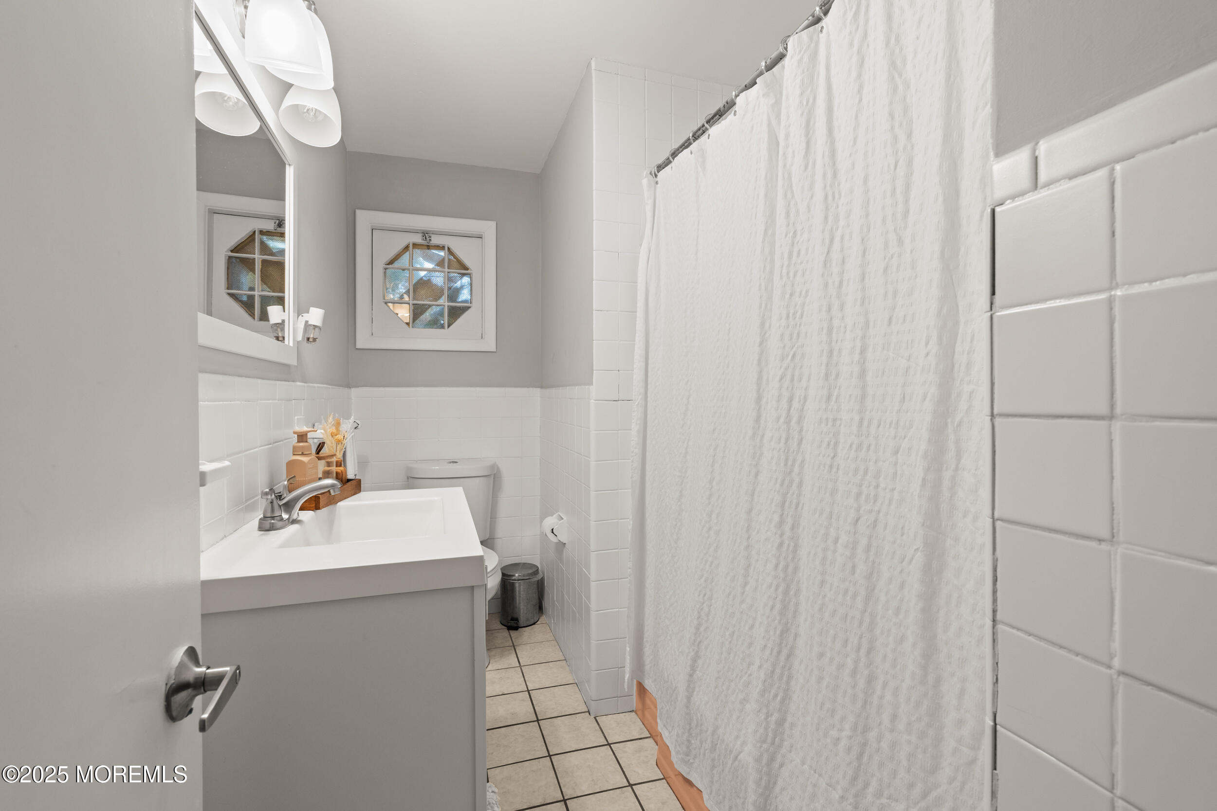 271 Jerome Avenue Oakhurst, NJ 07755 - Photo 19 of 39 a bathroom with a sink a toilet and a mirror