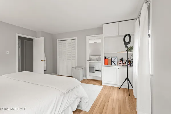 a bedroom with a bed and a wooden floor