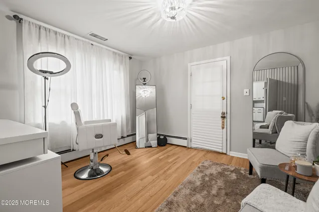 a bedroom with furniture and a mirror