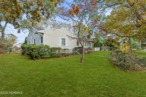a view of a house with a backyard