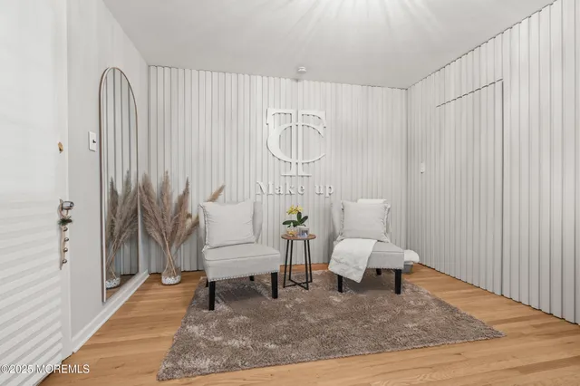 a living room with furniture and large windows