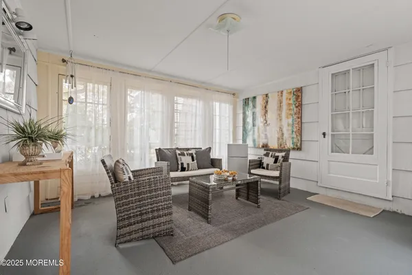 a living room with furniture and large windows