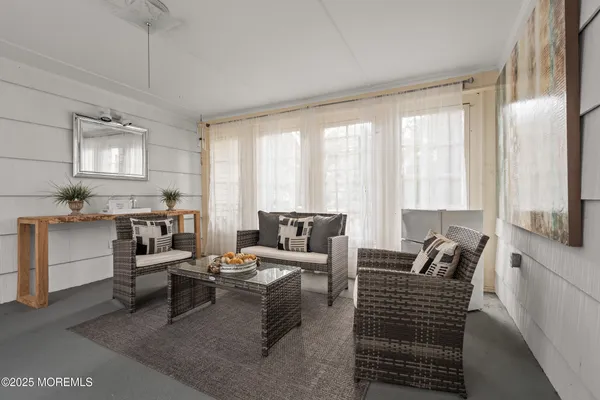 a living room with furniture and large windows