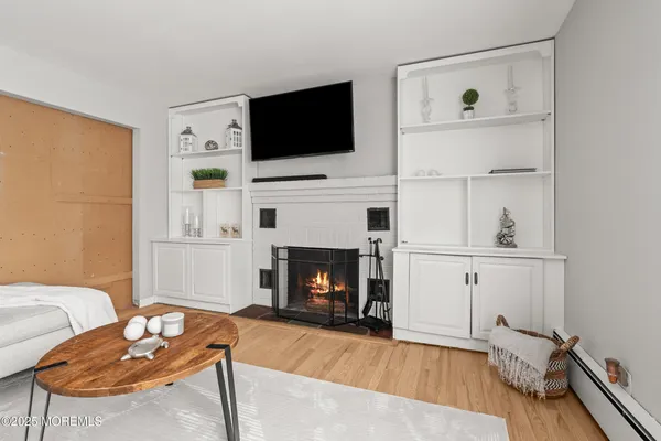 a living room with furniture fireplace and flat screen tv