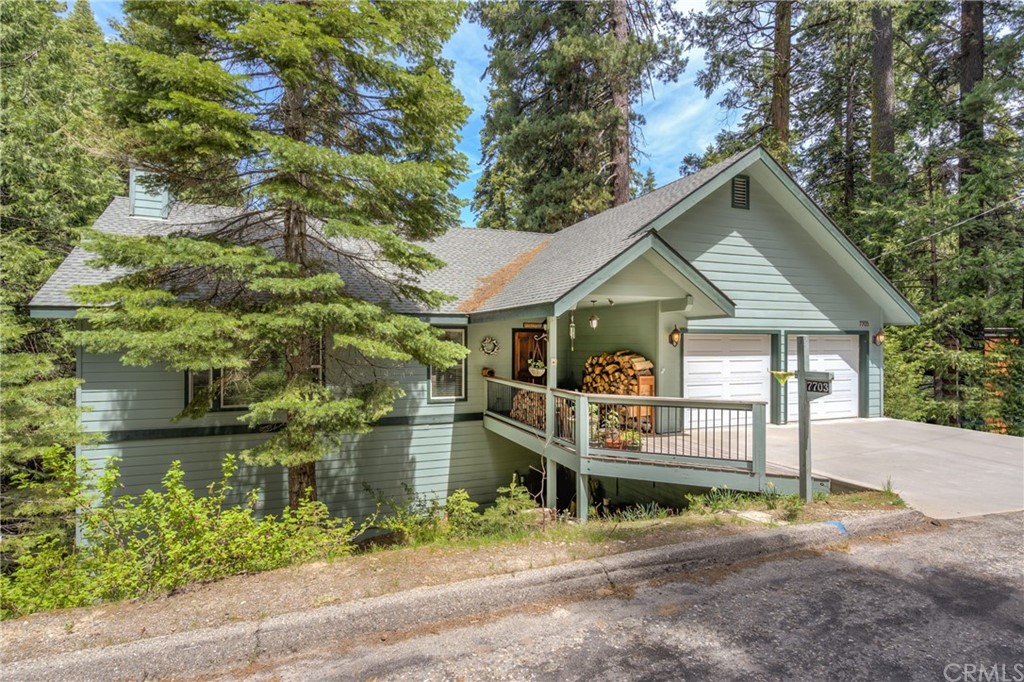 7703 Forest Drive Fish Camp, CA 93623 - Photo 2 of 48 a front view of a house with a yard and potted plants