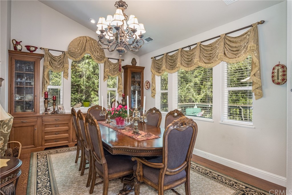 7703 Forest Drive Fish Camp, CA 93623 - Photo 11 of 48 a view of a dining room with furniture a chandelier and large window