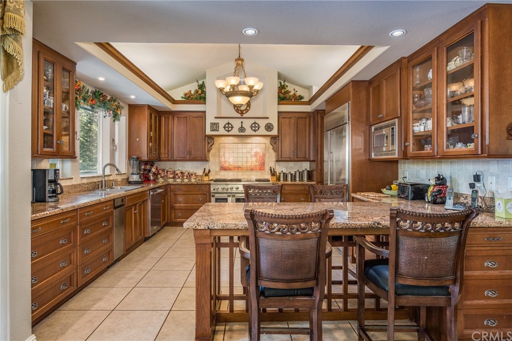 7703 Forest Drive Fish Camp, CA 93623 - Photo 14 of 48 a large kitchen with a table and chairs