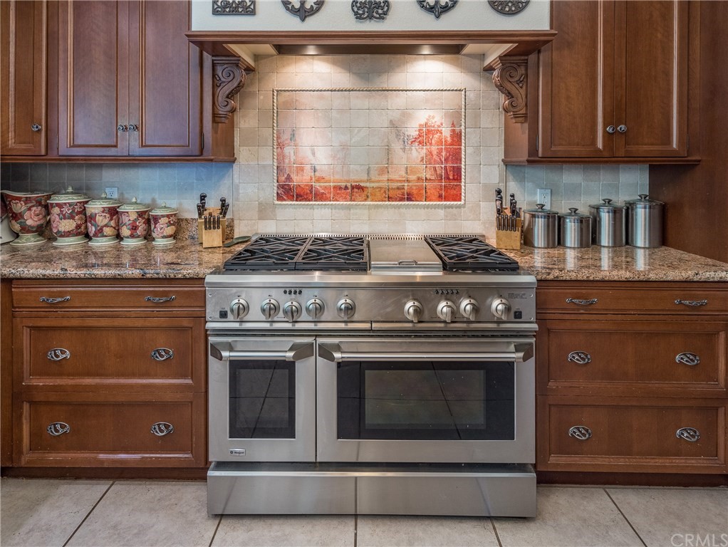 7703 Forest Drive Fish Camp, CA 93623 - Photo 16 of 48 a stove top oven sitting inside of a kitchen