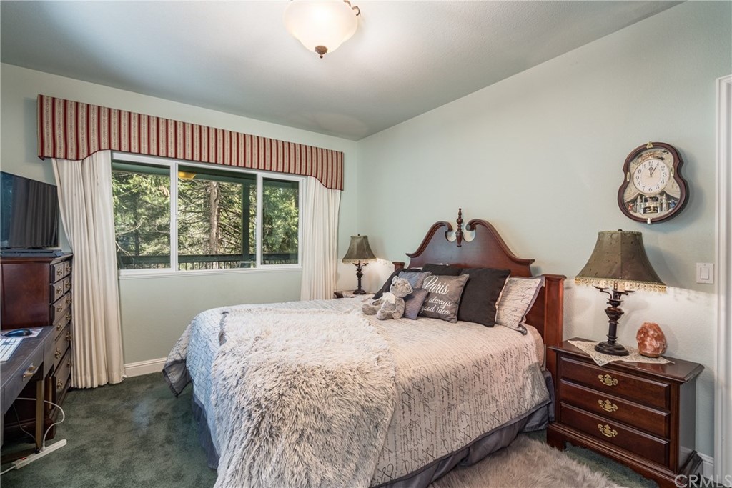 7703 Forest Drive Fish Camp, CA 93623 - Photo 27 of 48 a bedroom with a bed and a window