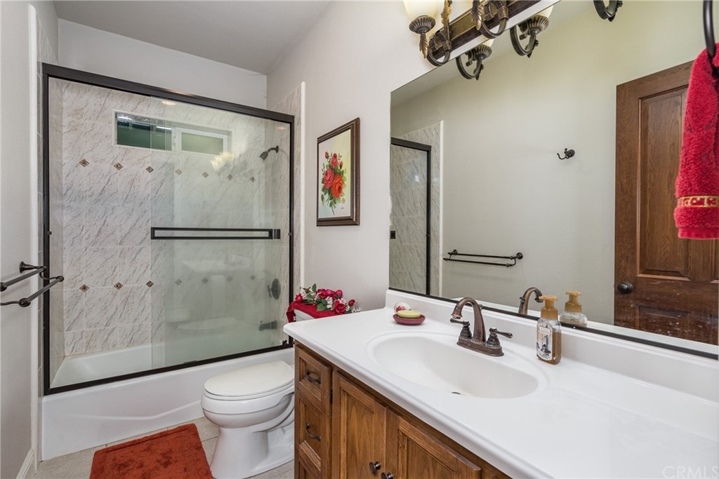 7703 Forest Drive Fish Camp, CA 93623 - Photo 28 of 48 a bathroom with a sink toilet and shower