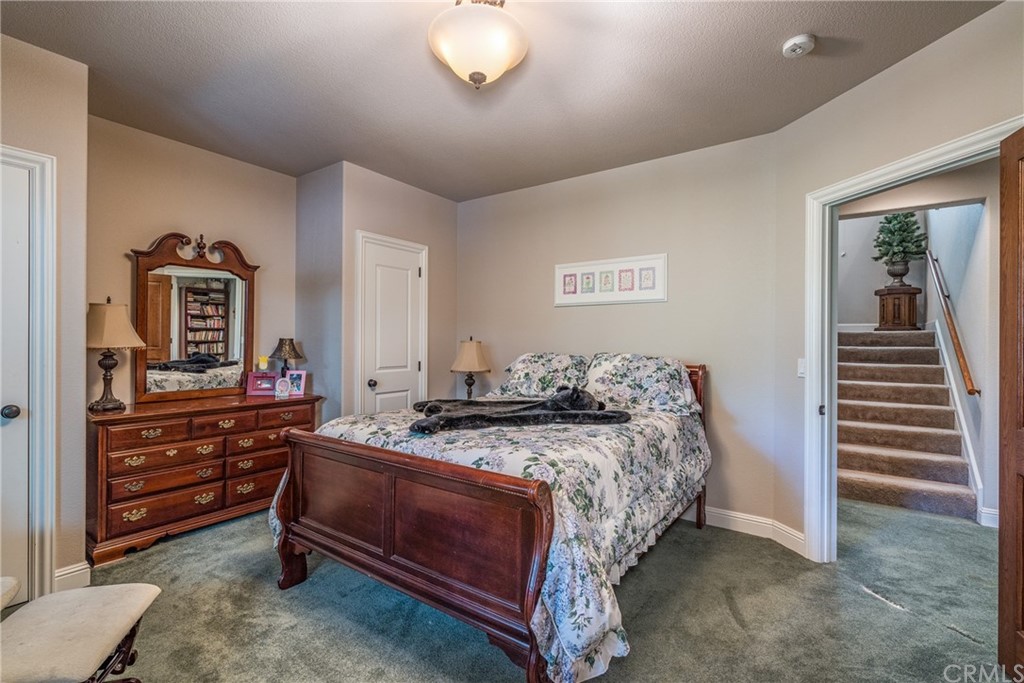 7703 Forest Drive Fish Camp, CA 93623 - Photo 30 of 48 a bedroom with a bed and a dresser