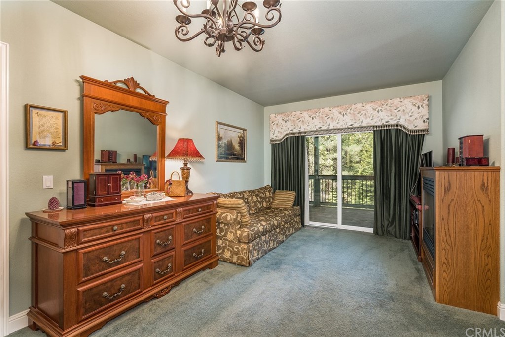 7703 Forest Drive Fish Camp, CA 93623 - Photo 33 of 48 a bed room with a bed mirror and a window