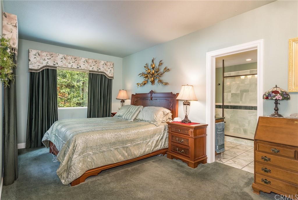 7703 Forest Drive Fish Camp, CA 93623 - Photo 34 of 48 a bedroom with a bed and a table