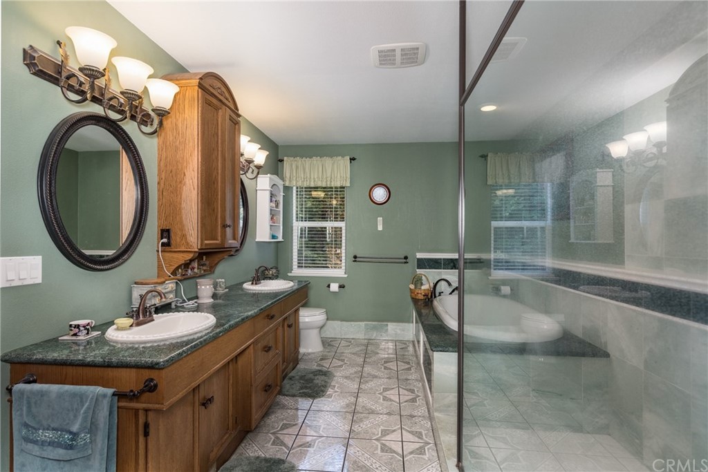 7703 Forest Drive Fish Camp, CA 93623 - Photo 36 of 48 a bathroom with a sink double vanity and a mirror