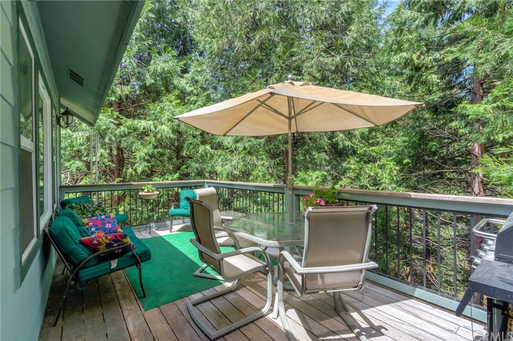 7703 Forest Drive Fish Camp, CA 93623 - Photo 42 of 48 a view of deck with furniture and barbeque grill with wooden floor