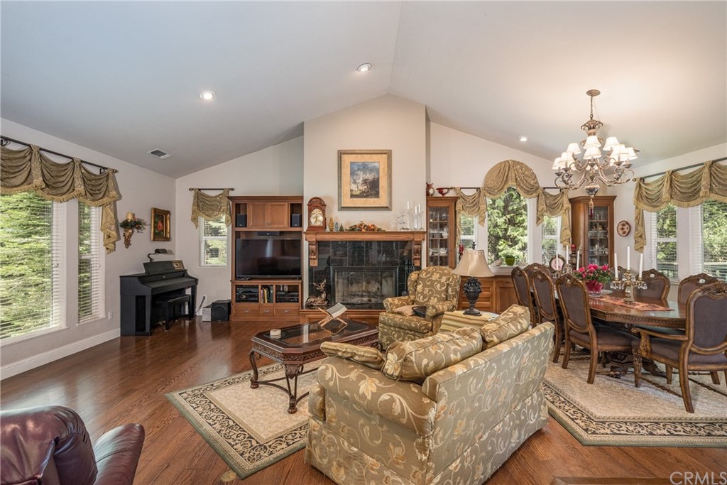 7703 Forest Drive Fish Camp, CA 93623 - Photo 9 of 48 a living room with fireplace furniture and a chandelier