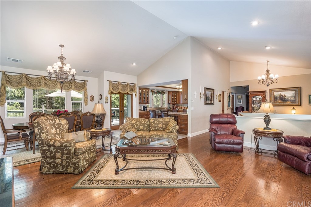 7703 Forest Drive Fish Camp, CA 93623 - Photo 10 of 48 a living room with furniture and a chandelier