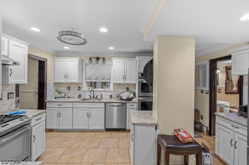2785 Larchmont Road Union, NJ 07083 - Photo 6 of 15 a kitchen with stainless steel appliances kitchen island granite countertop a sink and cabinets