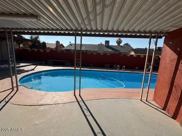 a view of a swimming pool with an outdoor seating