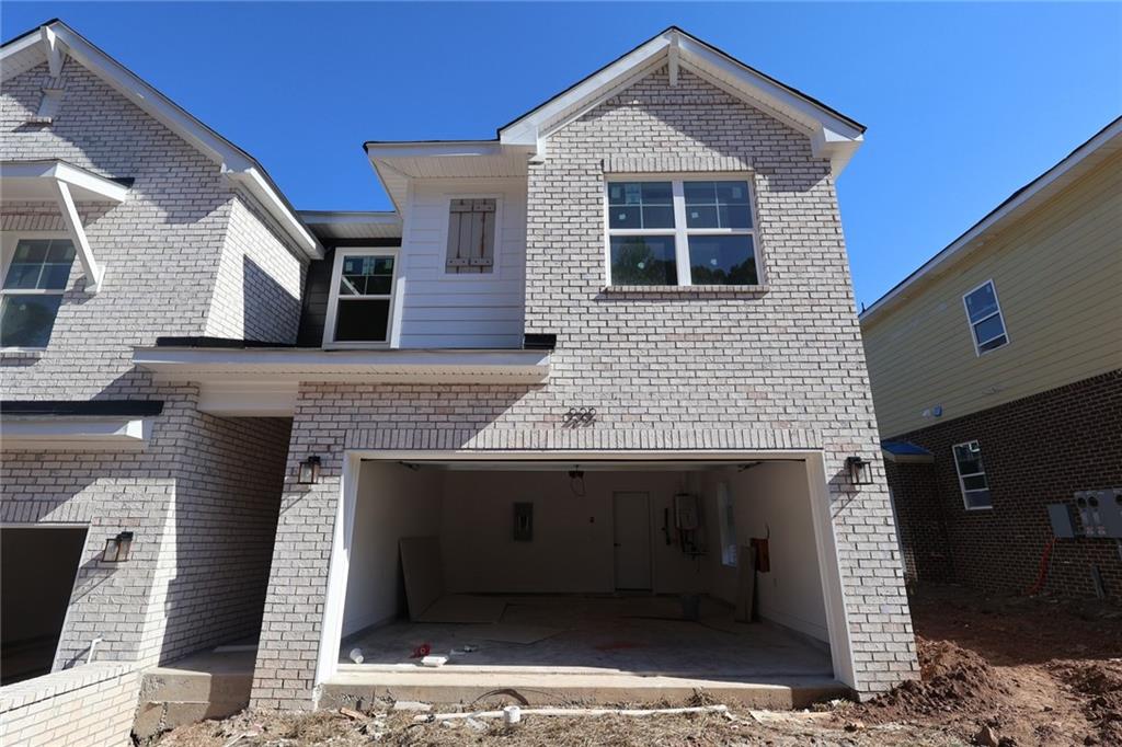 222 Redbud Road Canton, GA 30114 - Photo 2 of 10 a front view of a house with parking area