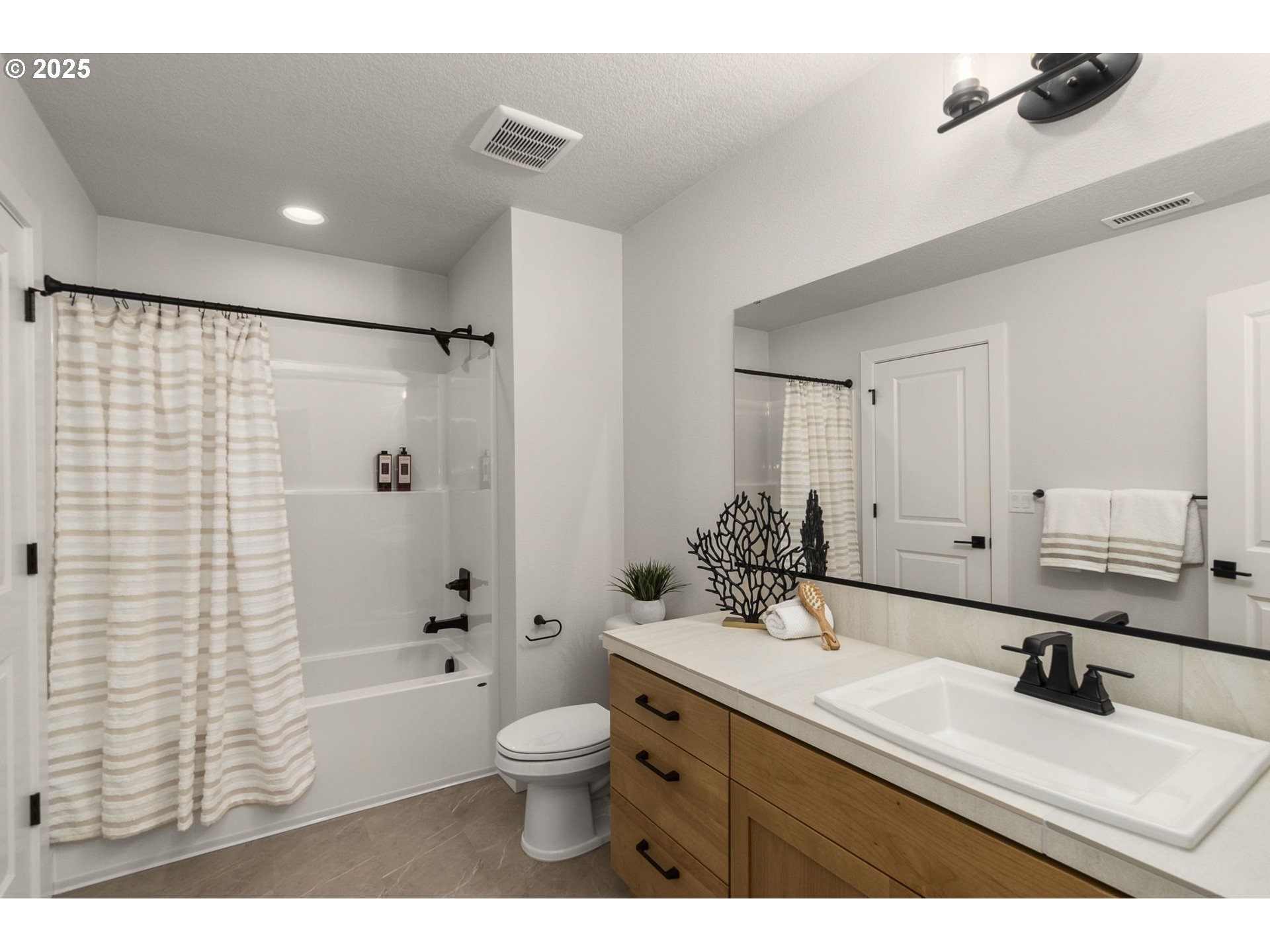 4117 South 14th Way Ridgefield, WA 98642 - Photo 17 of 20 a bathroom with a sink a toilet and shower