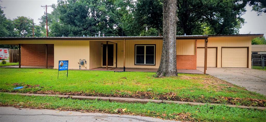 104 Elm Drive Terrell, TX 75160 - Photo 1 of 10 a front view of a house with garden