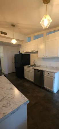 a view of a kitchen with a sink and dishwasher