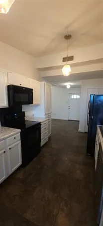a kitchen with stainless steel appliances a refrigerator and a stove