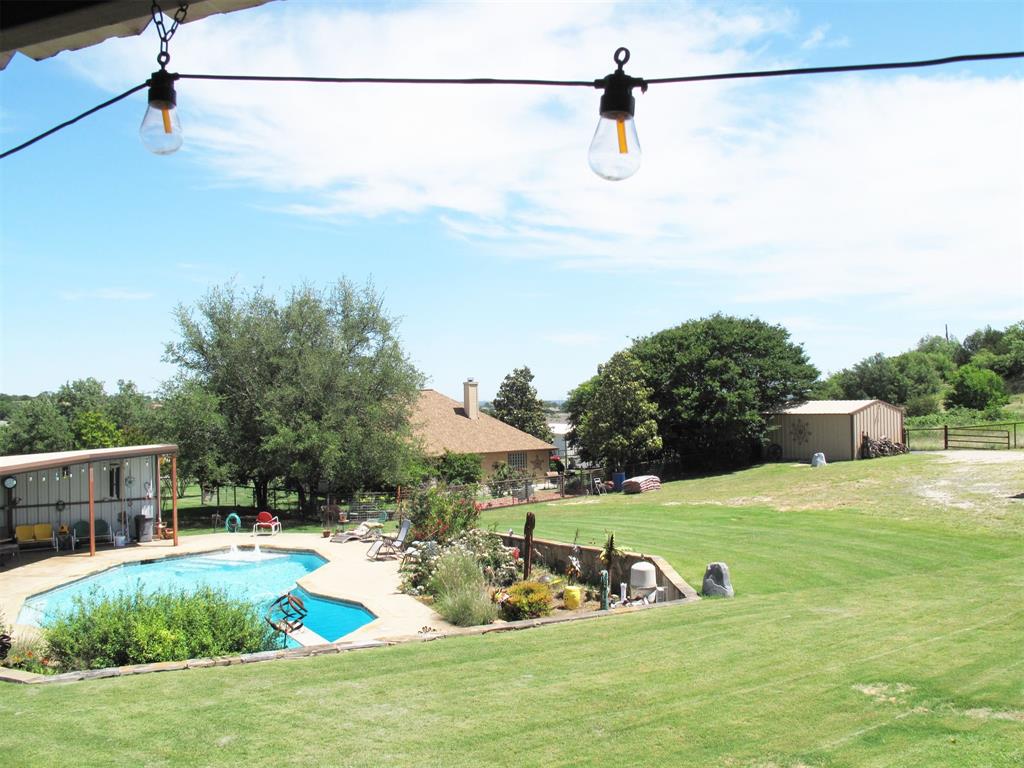 a view of a swimming pool with a yard