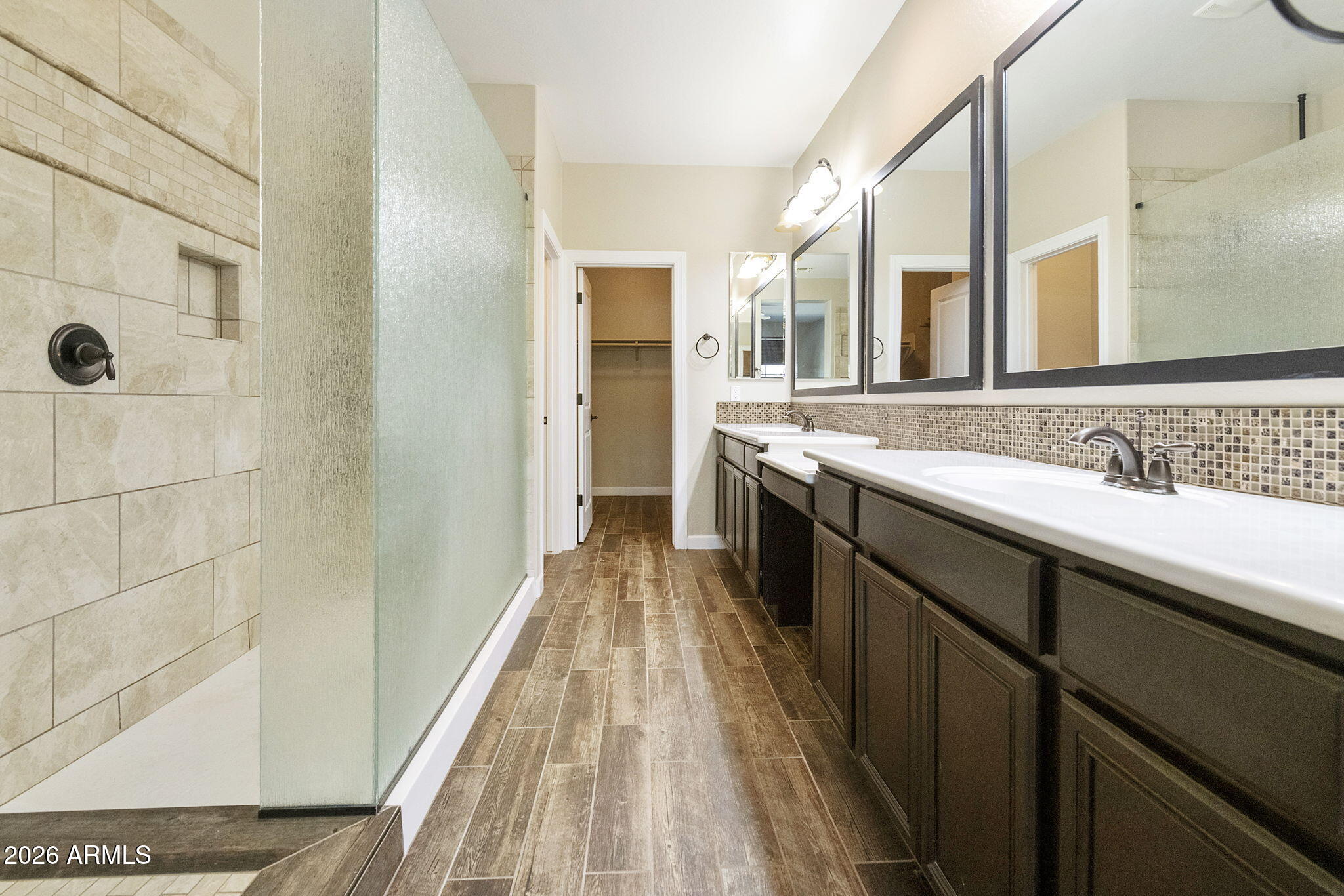 4777 South Fulton Ranch Boulevard, Unit 1123 Chandler, AZ 85248 - Photo 6 of 18 a bathroom with a sink a mirror and a shower