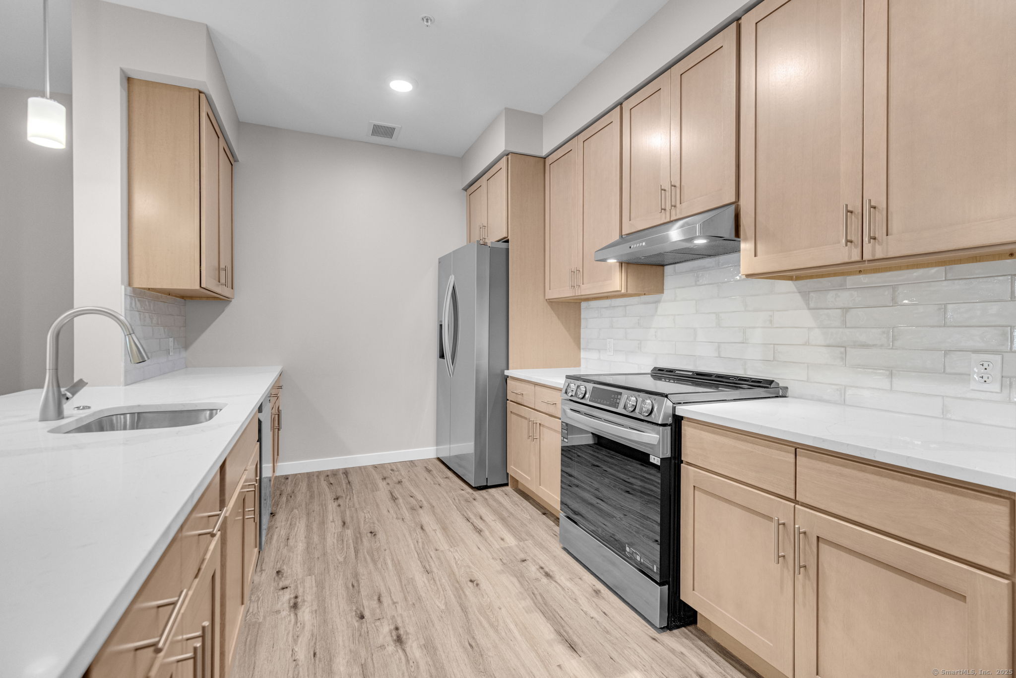 104 Episcopal Road, Unit 3 Berlin, CT 06037 - Photo 11 of 20 a kitchen with stainless steel appliances granite countertop a sink stove and refrigerator
