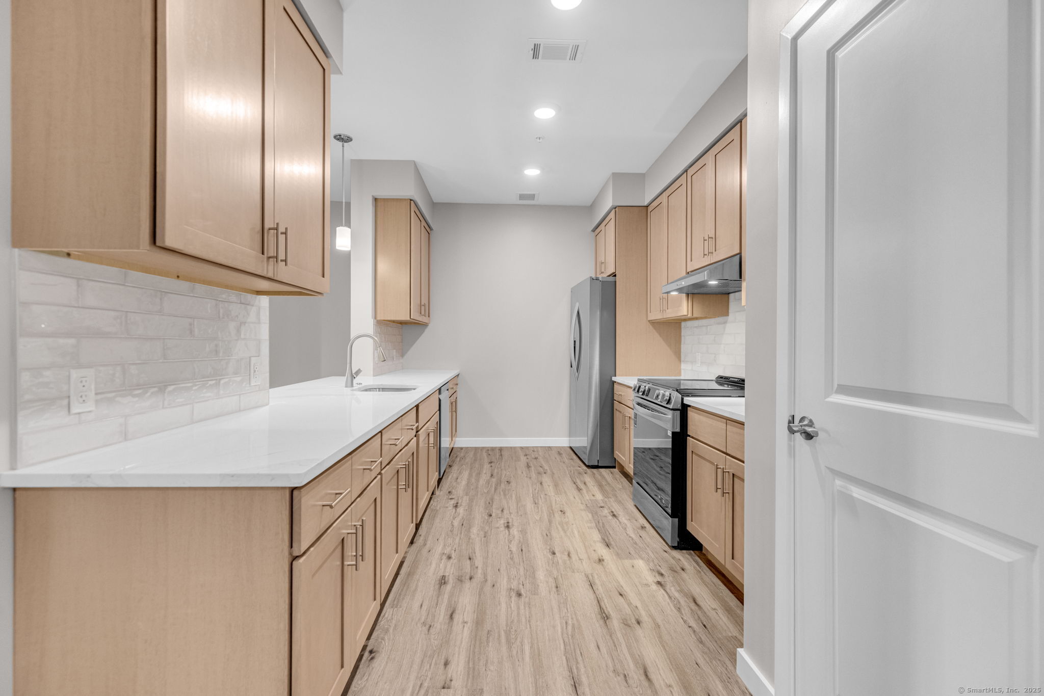 104 Episcopal Road, Unit 3 Berlin, CT 06037 - Photo 12 of 20 a kitchen with a sink and refrigerator