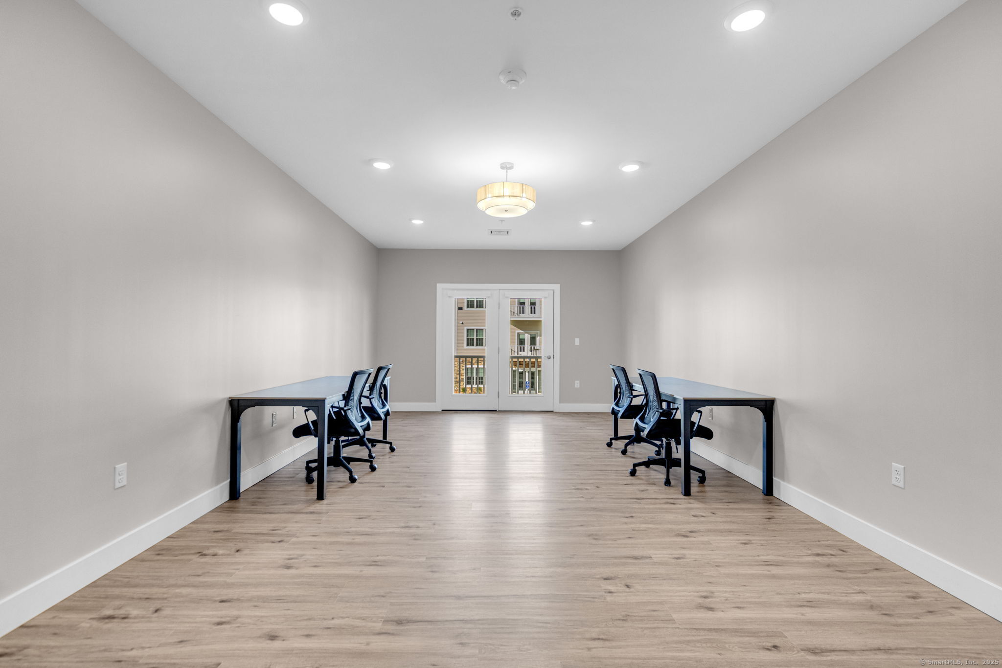 104 Episcopal Road, Unit 3 Berlin, CT 06037 - Photo 18 of 20 a view of a work space with furniture and wooden floor
