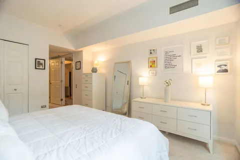 a bedroom with a bed and a dresser