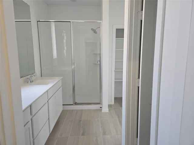 a bathroom with a double vanity sink and mirror
